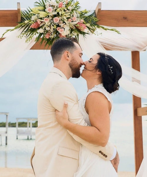 Happy couple kissing during wedding ceremony in Belize
