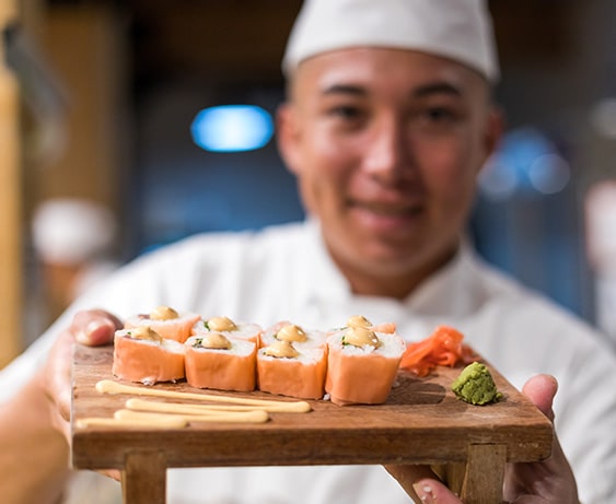 Jyoto chef holding sushi tray