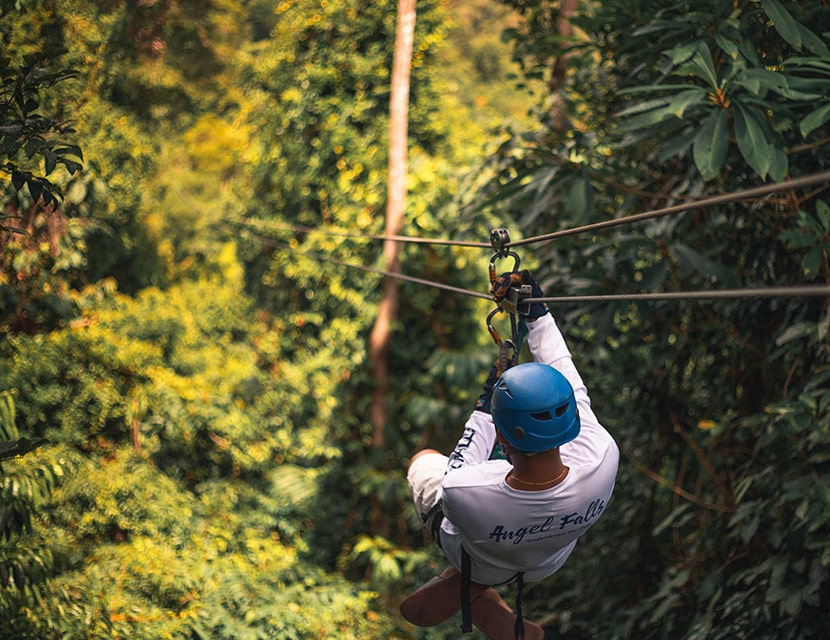 Man zip lining in the jungle