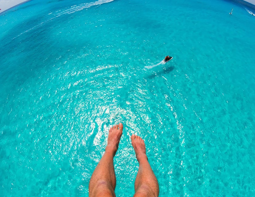 Person's feet high above the water