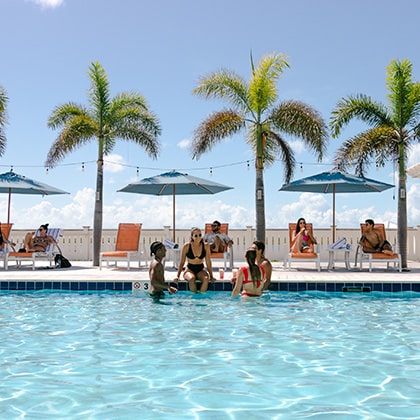 Group relaxing in the pool at the Bay Club at Mahogany Bay Resort & Beach Club