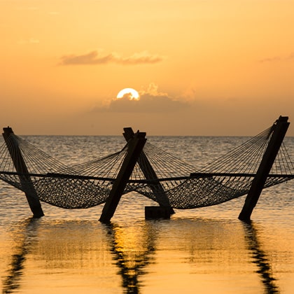 Sunsets on the overwater hammock at Mahogany Bay Resort & Beach Club