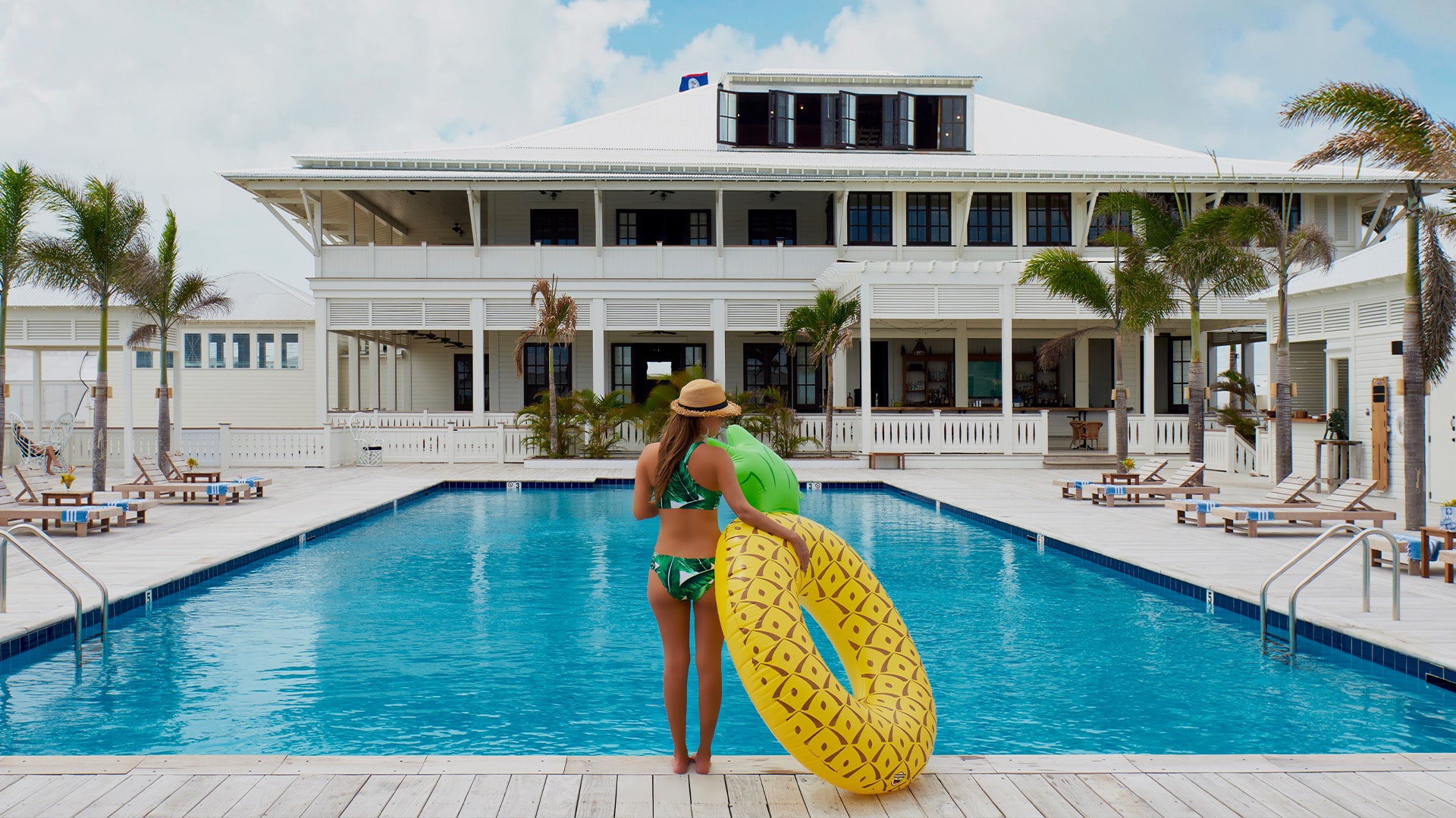 Woman with pool float at the pool at Mahogany Bay Resort & Beach Club