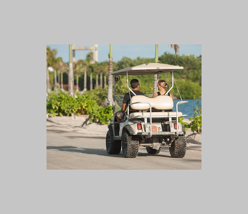 Driving in golf cart at Mahogany Bay Resort